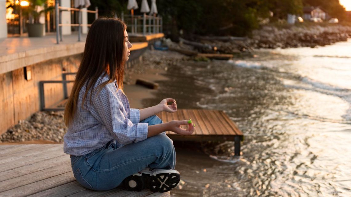 Sideview woman doing yoga