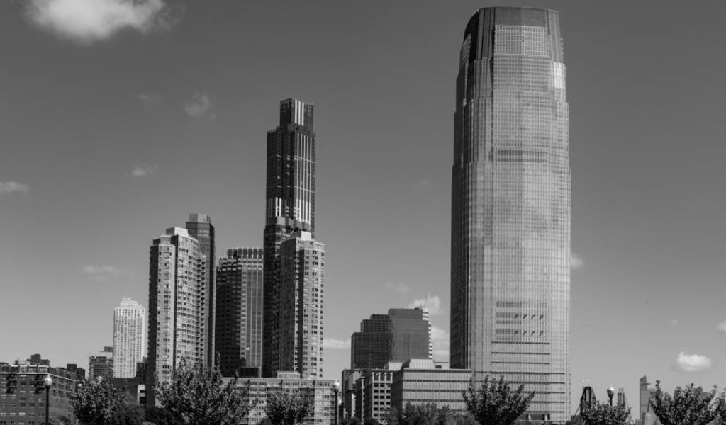 Black-and-white view of a city skyline with tall modern towers.