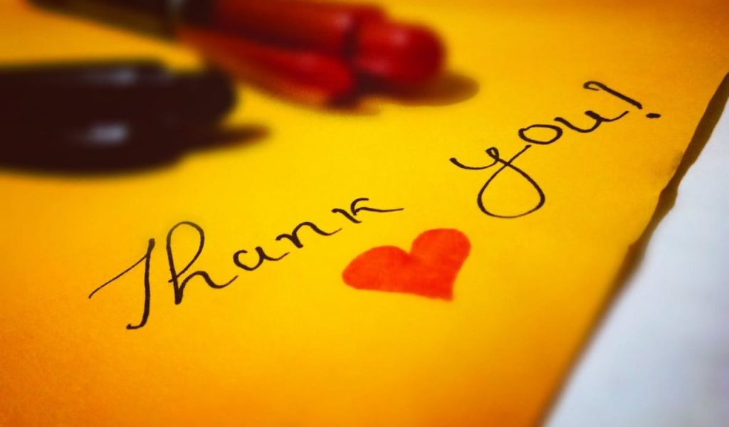 “Thank you!” handwritten on a yellow note with a small red heart.