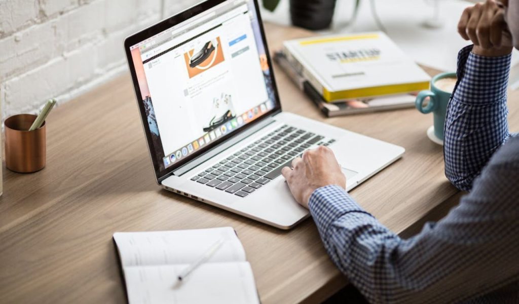 Person working on a laptop at a desk.