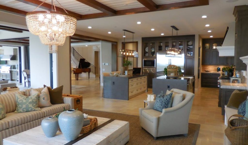 Open-plan living room and kitchen with chandelier lighting.