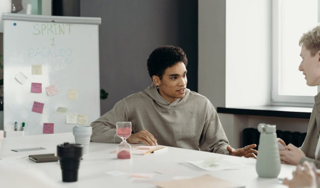 Coworkers discussing at a meeting table.