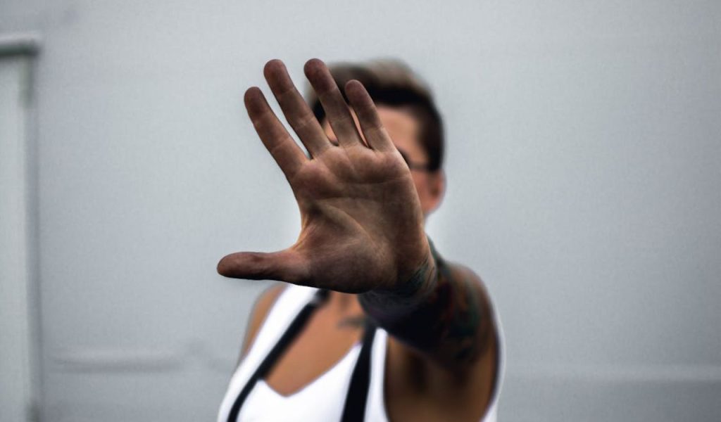 Hand up in a “stop” gesture.