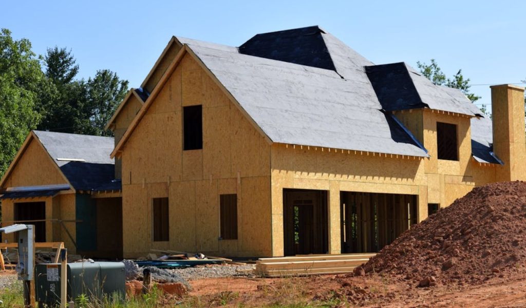 House under construction with framing and roof sheathing.