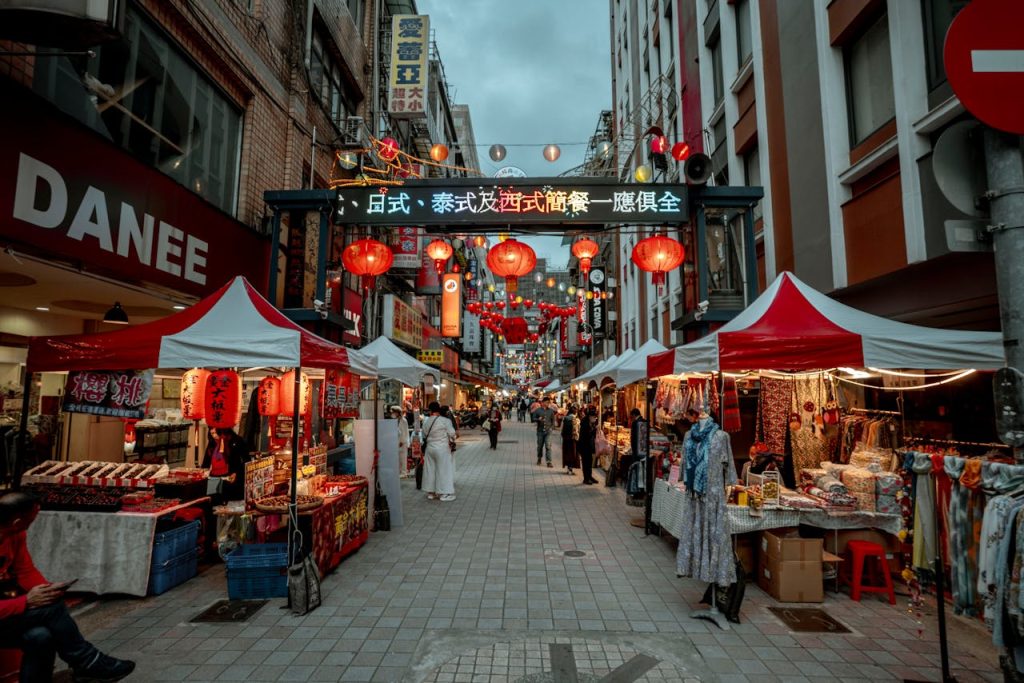 Busy night market alley filled with food stalls