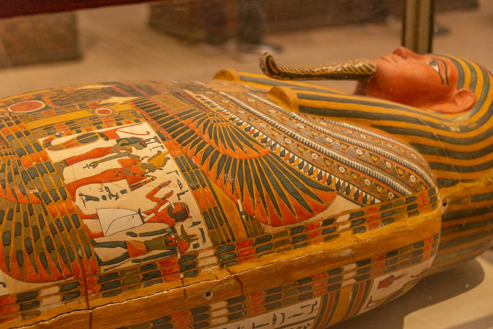 Close-up image of an ornately ornamented Egyptian sarcophagus with hieroglyphs and intricate designs.