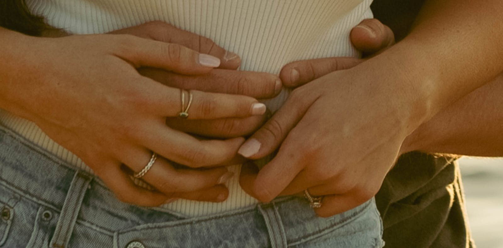 Close-up of couple's hands embracing, showcasing affection and intimacy.