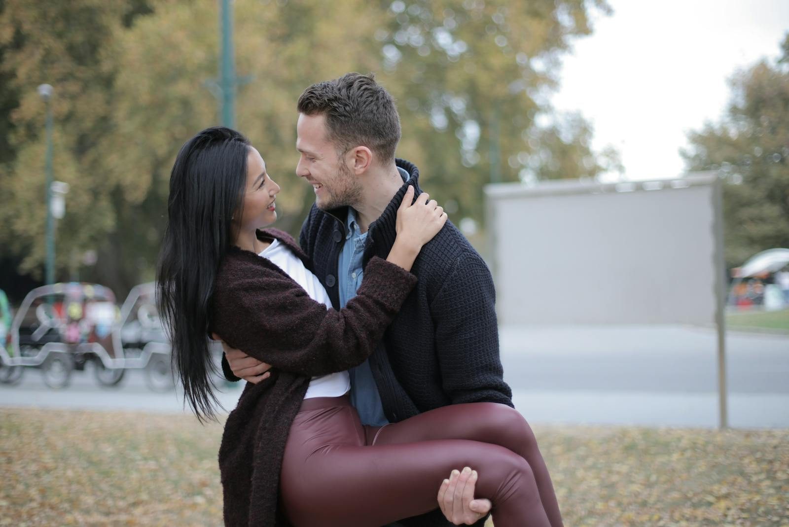Happy couple in love enjoying a romantic moment outdoors. Smiling and bonding in a park setting.