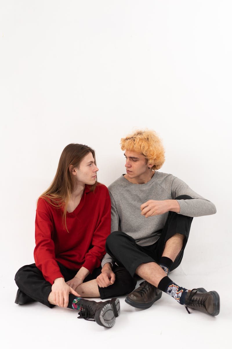 Two young adults sitting close, exuding a sense of warmth and intimacy.