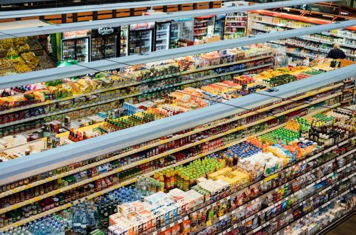 Explore the colorful, fully-stocked shelves of a bustling supermarket from above.