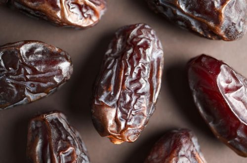 High-resolution close-up of wrinkled Medjool dates showcasing texture and rich color.