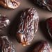 High-resolution close-up of wrinkled Medjool dates showcasing texture and rich color.