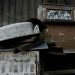 Aged and rusty appliances against a weathered wooden wall, capturing decay.
