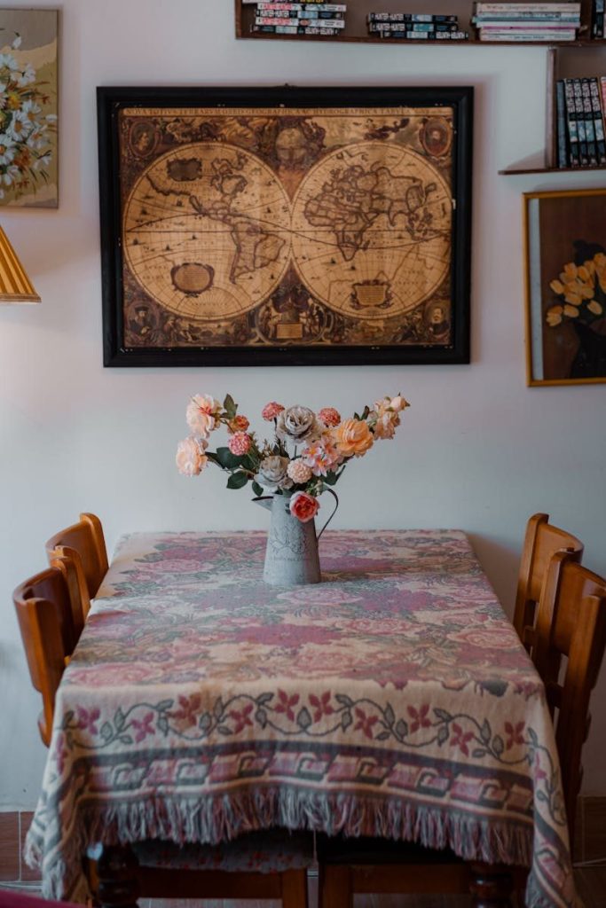 Cozy dining room featuring a vintage map and floral arrangement.