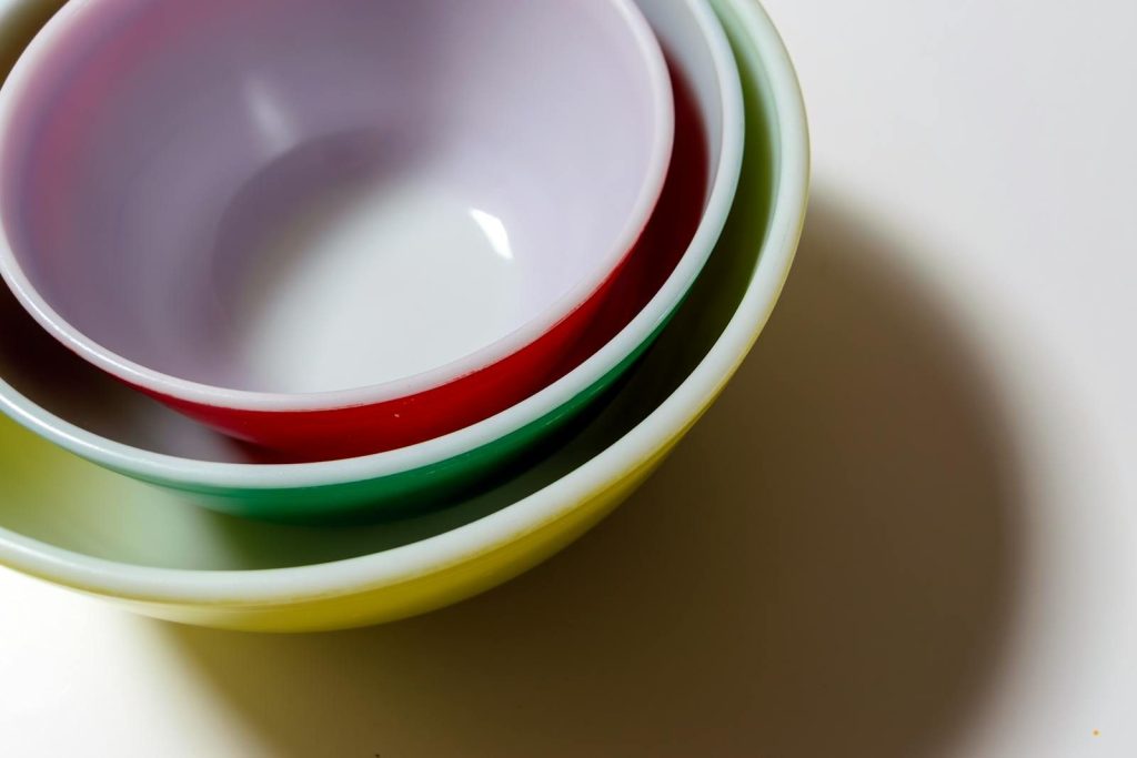 Close-up of colorful vintage bowls stacked together showcasing a retro aesthetic.