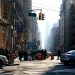 A bustling street scene in New York City with cars and people during daytime.
