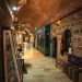 Explore a historic bazaar's interior corridor adorned with traditional decor and cultural artifacts.