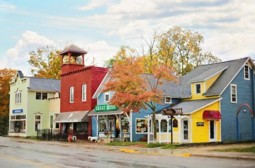 A vibrant street scene with colorful buildings and quaint shops under autumn skies.