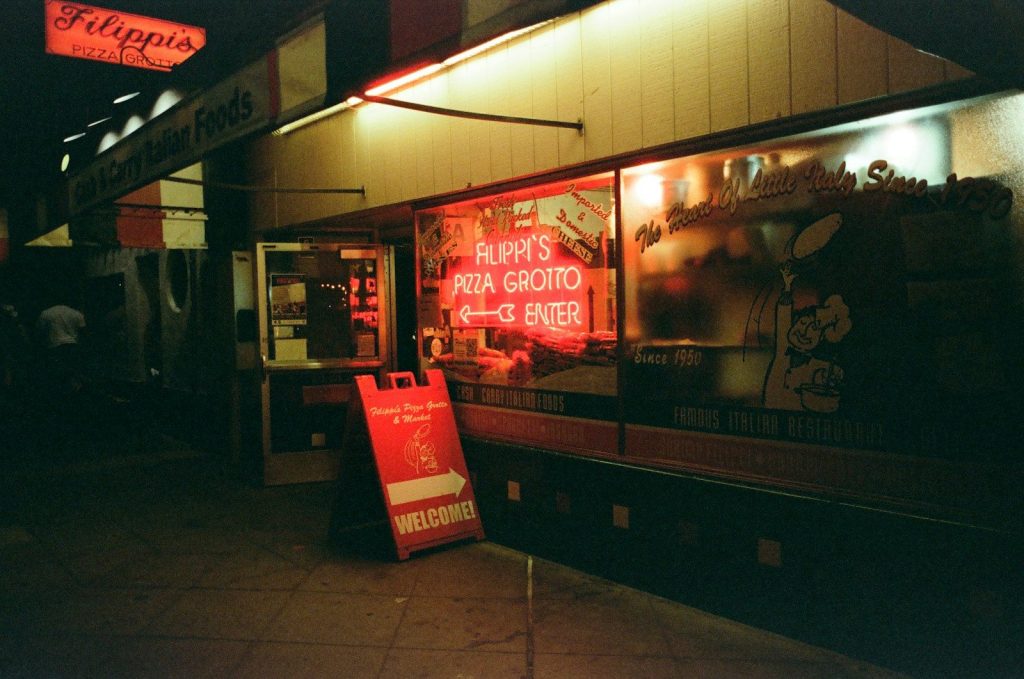 Neon sign for pizza place at night