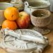 stack of orange and apples by pots on table top