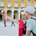 A couple takes a selfie in a beautiful square.